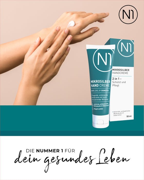 N1 Mikrosilber Handcreme 50ml im Gebrauch auf Händen, antibakterielle und pflegende Eigenschaften, Tube und Verpackung sichtbar.